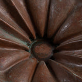 Vintage brutalist copper bowl with fluted design and aged patina.